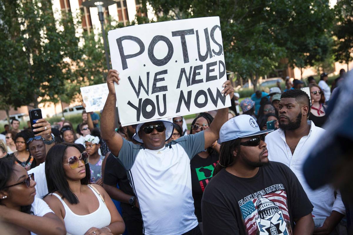 People rally in Dallas, Texas, on July 7, 2016 to protest the deaths of Alton Sterling and Philando Castile. Black motorist Philando Castile, 32, a school cafeteria worker, was shot at close range by a Minnesota cop and seen bleeding to death in a graphic video shot by his girlfriend that went viral Thursday, the second fatal police shooting to rock America in as many days. / AFP PHOTO / Laura Buckman